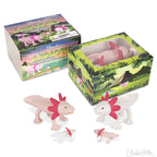 The Box of Axolotls displays a charming collection of soft vinyl axolotl figures in pink and white, showcasing a family of four in different sizes against jungle-themed packaging.