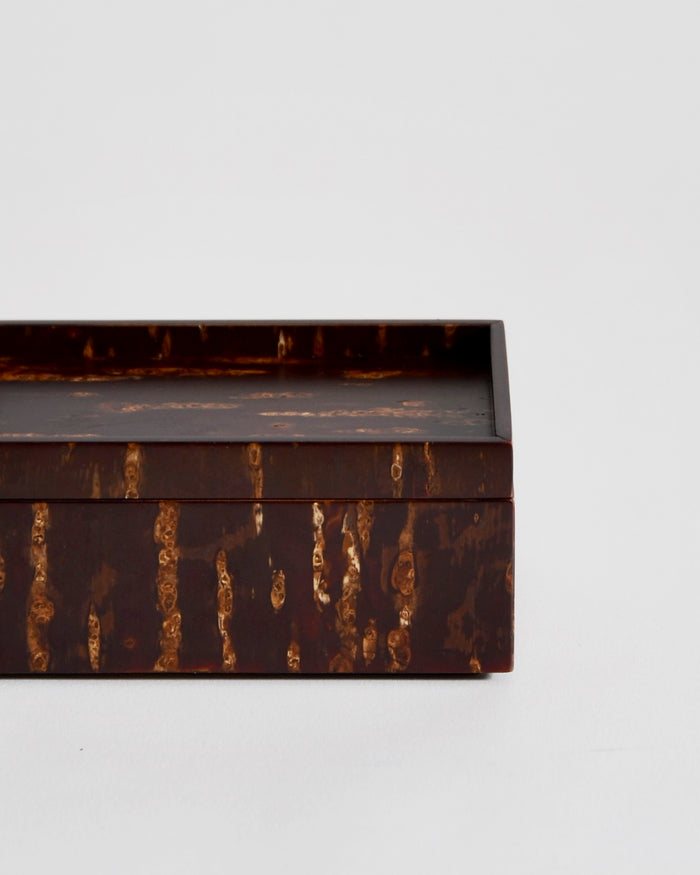 Up close view of wooden box by Denshiro on a light gray background