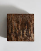 Top view of square wooden box with a textured surface by Denshiro on a light gray background