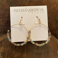 These gold circle earrings with crystals and beads add a unique touch to any wardrobe. Crafted with dainty mint green, gray, gold, and gray crystal beads, these earrings are perfect for adding a touch of subtle sparkle. Wired earrings make them easy to wear.