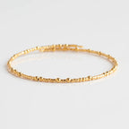 Brighten any outfit with a Confetti Bangle Bracelet! This wrap-style bangle features fun confetti-style beads, with small and larger ones mixing together for a delicate, cheerful look. Show your personality and add a splash of color to any style