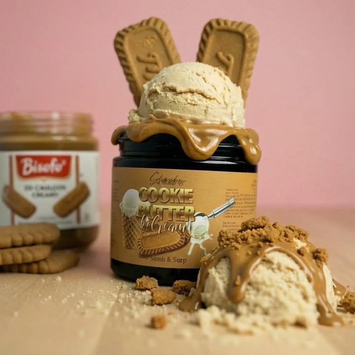 Cookie butter ice cream jar topped with ice cream scoop, biscuit cookies, and caramel sauce