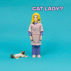Against a blue background, the Crazy Cat Lady® Action Figure stands beside a cat figurine, featuring a woman in a robe with six playful cats nestled in her hair and the text, "Crazy Cat Lady?