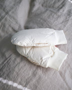 Beige hand warmers by Iwata on a gray textured surface