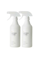 Two white spray bottles with Korean text on a white background