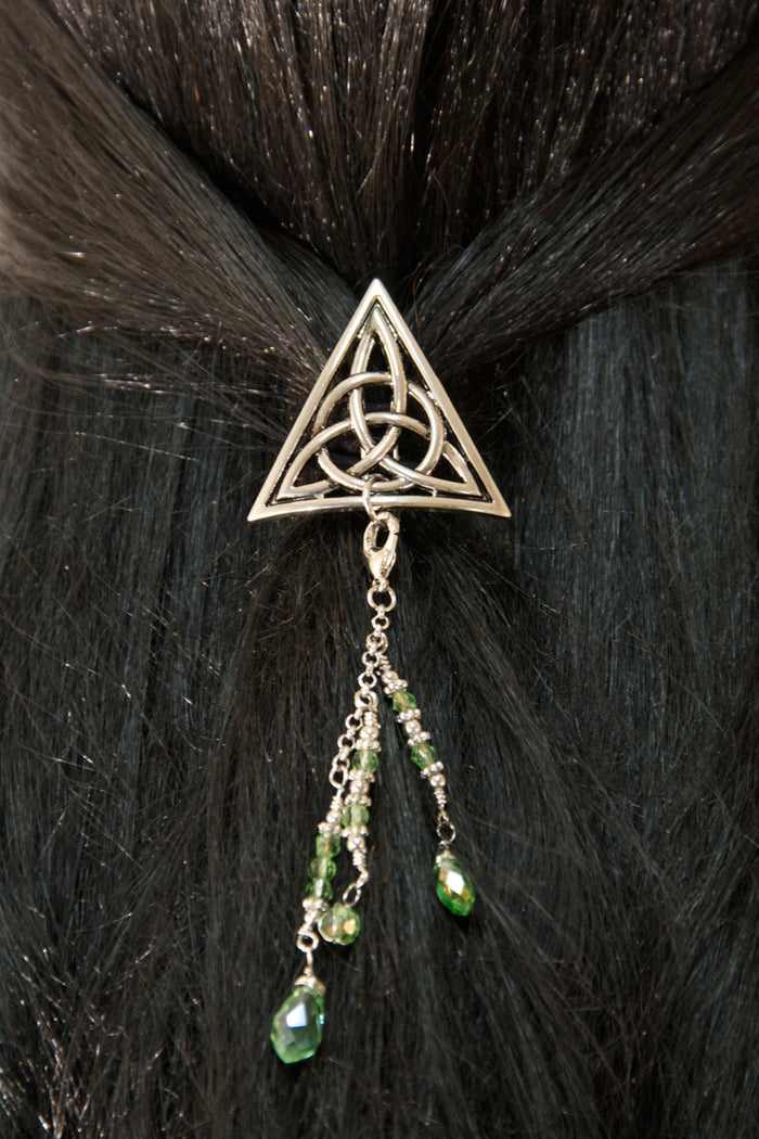 Silver Celtic triangle hair hook with green bead charms worn in dark hair