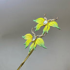 Handmade Chanhua deer floral hair pin with gradient yellow-green petals and crystal accents on a plain gray background