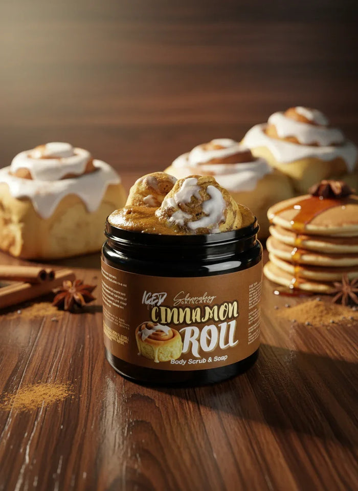 Iced cinnamon roll body scrub and soap jar with frosted rolls, pancakes, and spices on wood table