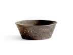 A brown textured bowl against white background.