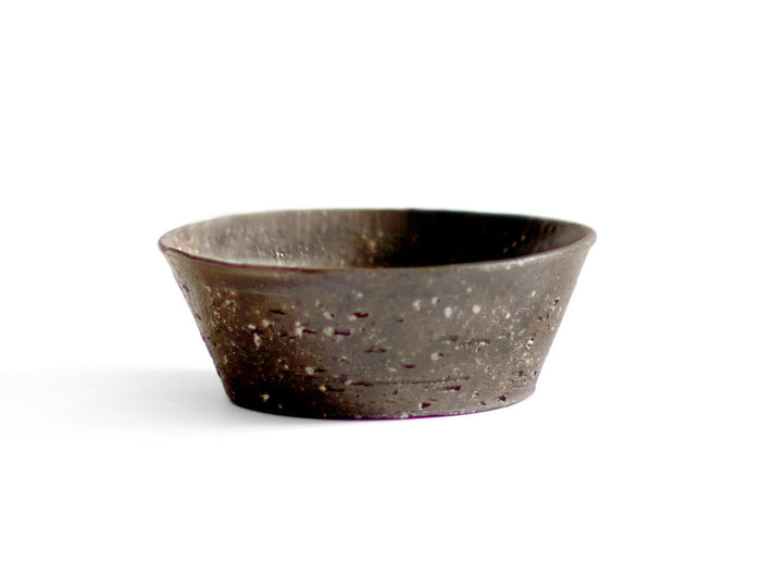 A brown textured bowl against white background.