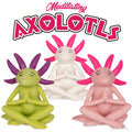 A set of three vibrant, collectible axolotl figures is depicted sitting cross-legged with eyes closed, capturing the essence of mindfulness under the title "Meditating Axolotls.