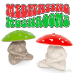 Two collectible figures of mushrooms with red and green caps sit in meditation beneath the text "Meditating Mushrooms.