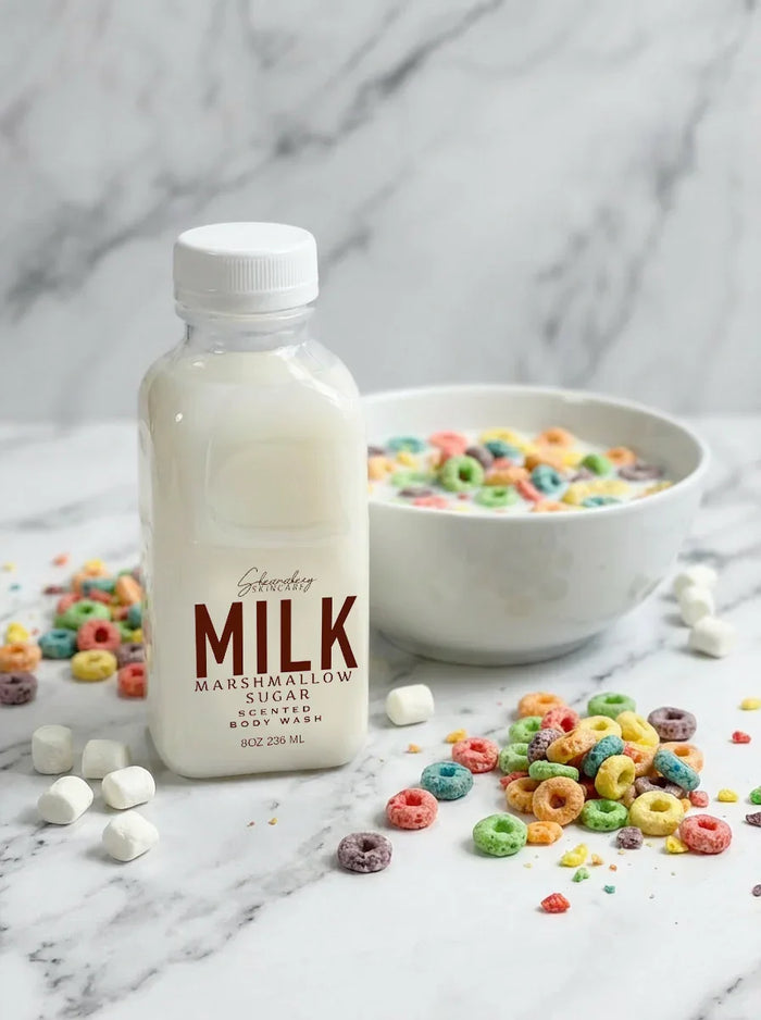 Marshmallow sugar scented body wash bottle with colorful cereal and mini marshmallows on marble