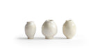 Silhouetted image of 3 varying mini white glazed mini vases from the Mini Vase Set - Trio I by Dani Sujin x Nalata Nalata against white background.