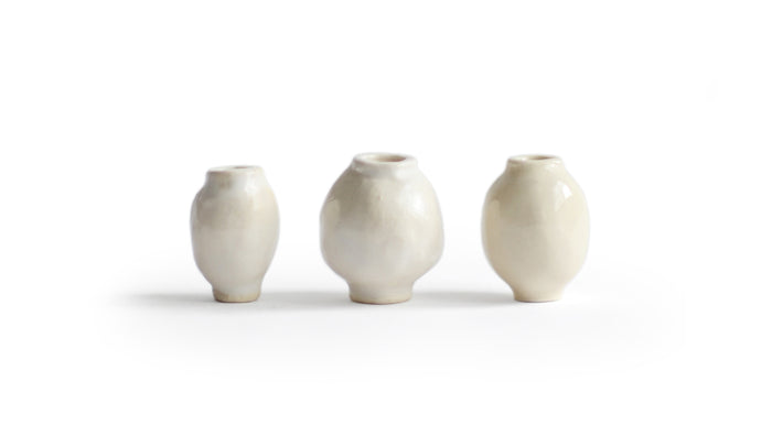 Silhouetted image of 3 varying mini white glazed mini vases from the Mini Vase Set - Trio I by Dani Sujin x Nalata Nalata against white background.