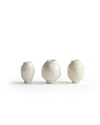 Silhouetted image of 3 varying mini white glazed mini vases from the Mini Vase Set - Trio I by Dani Sujin x Nalata Nalata against white background.