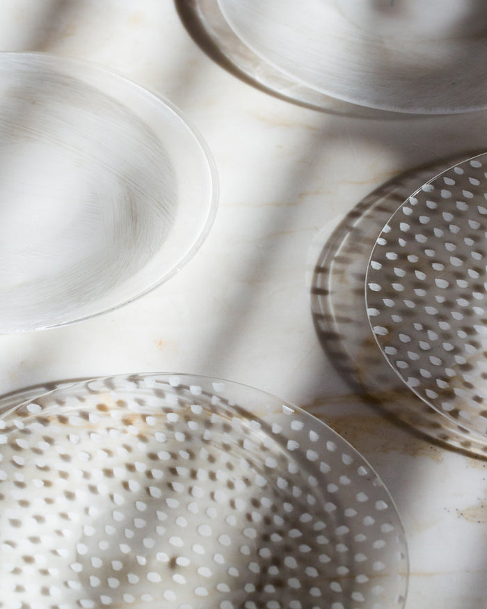 Cropped image of four oval plates next to each other. The top two plates are in brush pattern and the bottom two are in ten ten dot pattern.