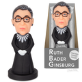 A Ruth Bader Ginsburg Nodder, portraying Supreme Court Justice Ruth Bader Ginsburg wearing a black robe with a dissent collar and glasses, is displayed next to its packaging.