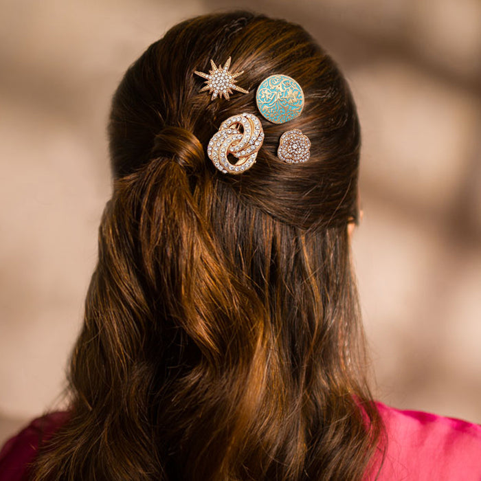 Close-up of a person's hair with decorative hairpins against a blurred background