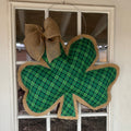 Green plaid shamrock doorhanger with burlap bow.