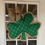 Green plaid shamrock doorhanger with burlap bow.
