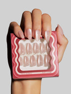 Hand holding a box of press-on nails with 'Celebritips' branding.