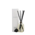 Diffuser bottle with black sticks and packaging on a white background
