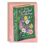 Greeting card with a book with a floral design and 'A Most Enchanted Birthday' text on a pink background