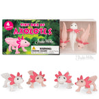Tiny Box of Axolotls includes a set of four pink figurines featuring wide smiles and playful poses.