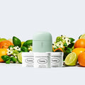 Fussy's Tropic Tonic Deodorant Starter Pack with Mint Green case, set against a backdrop of limes, mandarins and basil leaves