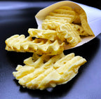 Realistic waffle fries soap in a paper pouch on a black surface, dessert-inspired body care